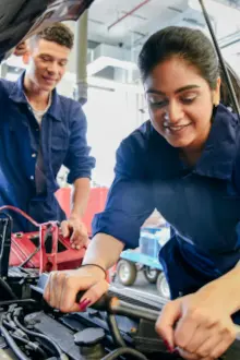 two mechanics working on a car