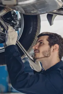 mechanic under a tyre